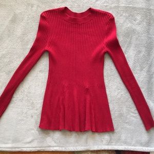Red crew neck sweater.